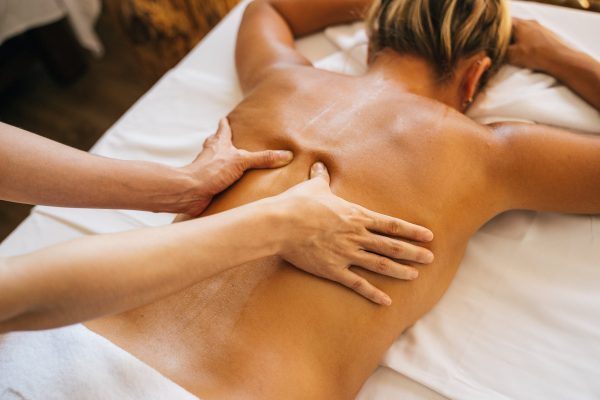 a-person-massaging-a-clients-bare-back a-person-massaging-a-clients-bare-back